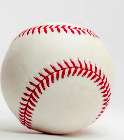 Close-up of a white baseball with red stitching on a plain white background