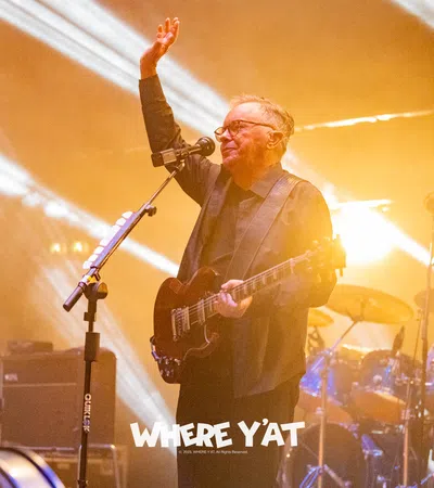 a person playing a guitar on a stage with a microphone