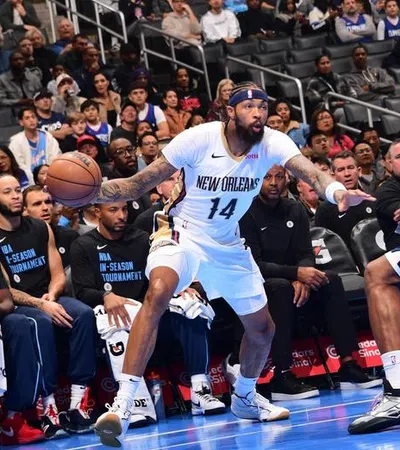 a basketball player dribbling the ball in front of a crowd