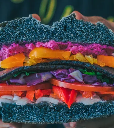 a person holding a burger