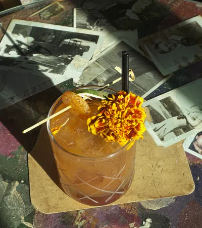 a glass with a straw and a pile of money on a table