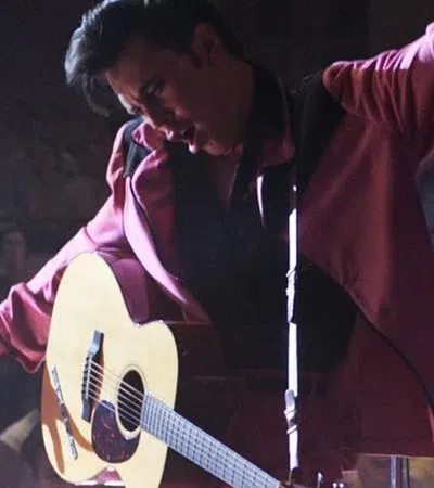 a person playing a guitar on a stage
