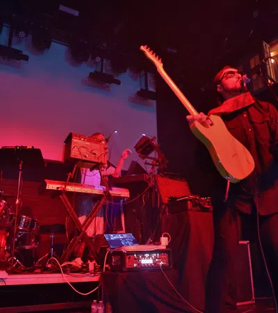 a man playing a guitar on a stage