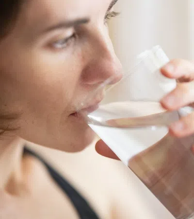 a woman drinking from a glass
