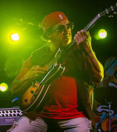 a person playing a guitar on a stage