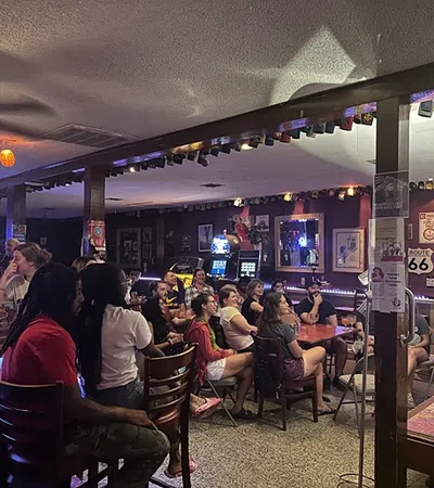 a group of people sitting at a bar