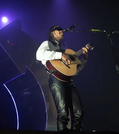 a person playing a guitar on a stage
