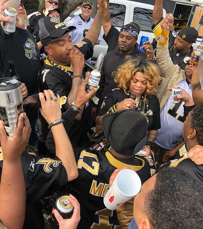 a crowd of people holding cans