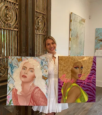 a group of people holding paintings