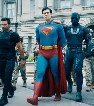 Superheroes including Superman and armed soldiers walking together in front of a classical government building.