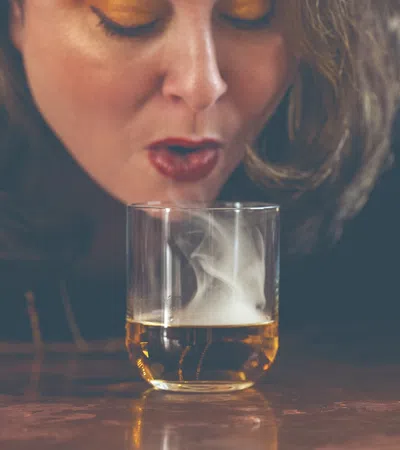 a person drinking from a glass