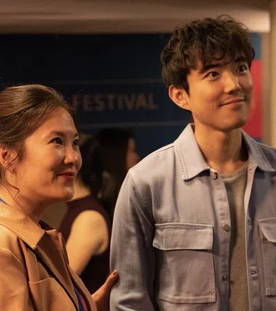a man and a woman standing in a room with people