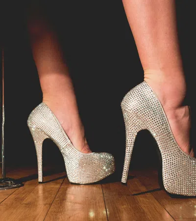 a pair of feet wearing high heeled shoes