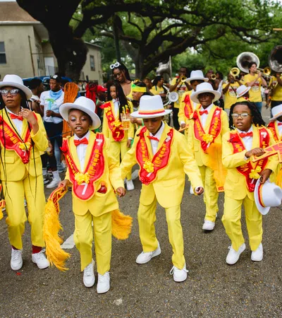 a group of people in clothing walking down a street