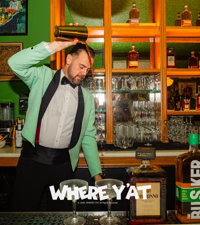 a man standing behind a bar