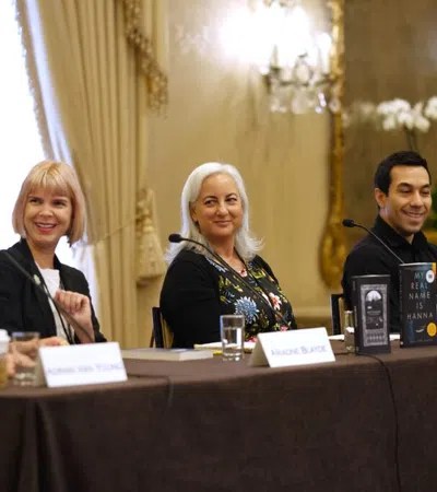 Tara L. Masih et al. sitting at a table with microphones