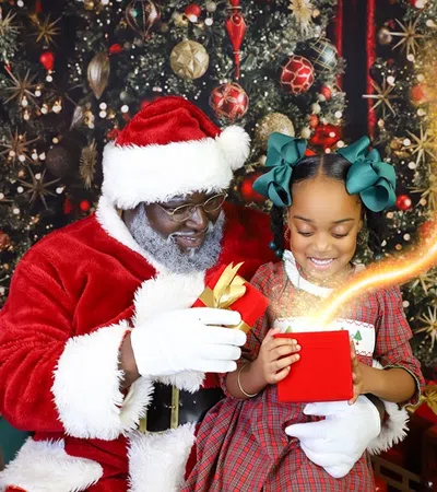 a person and a child in santa clause outfit holding a box