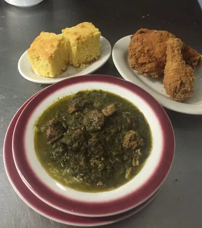 a bowl of soup next to plates of food