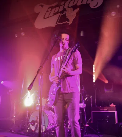 a person playing a guitar on a stage