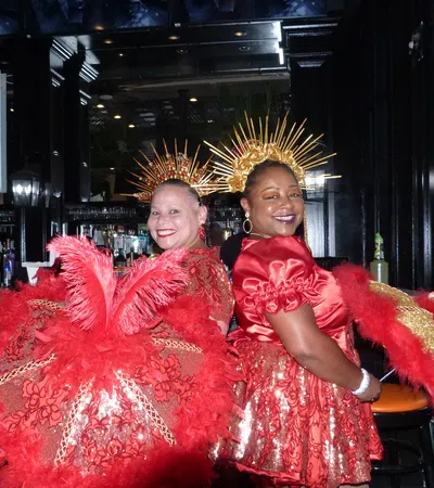 two women wearing red dresses