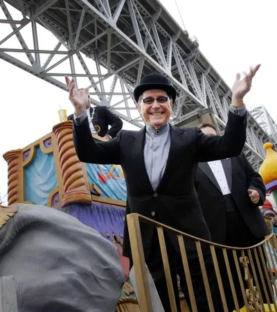 a person in a black hat and suit standing on a roller coaster