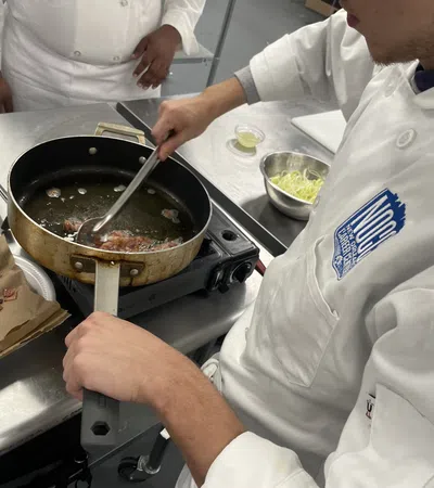 a chef cooking food in a kitchen