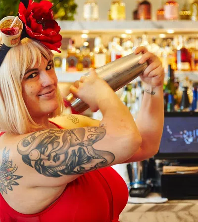 a person holding a bottle of alcohol