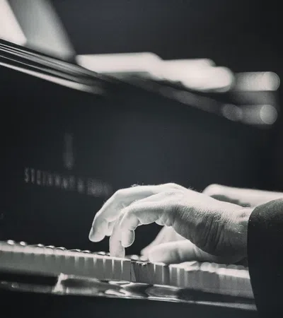 close-up of hands playing piano