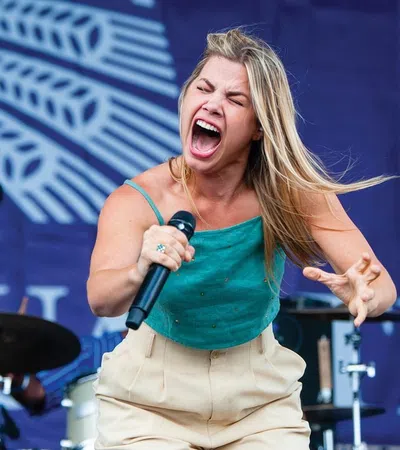 a woman singing into a microphone