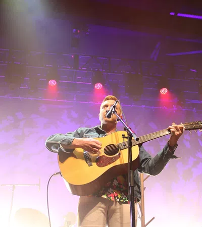 a person playing a guitar on a stage