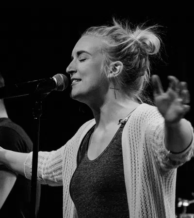 a woman singing into a microphone