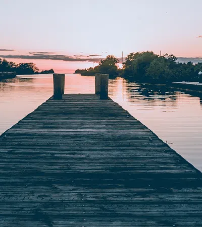 a dock with a boat in the water