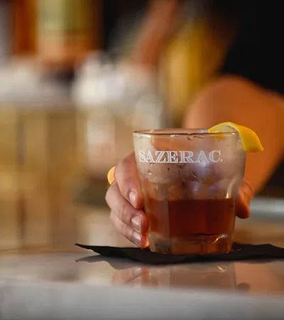 a glass of liquid with a lemon