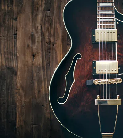 a guitar leaning against a wall