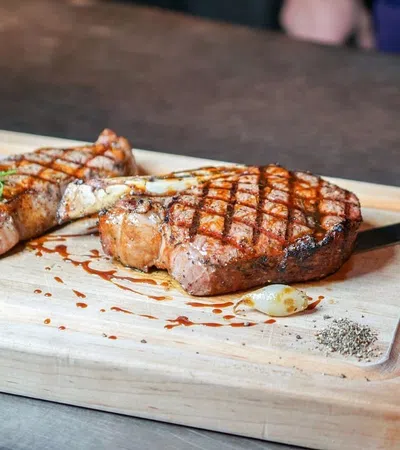 a couple pieces of meat on a cutting board