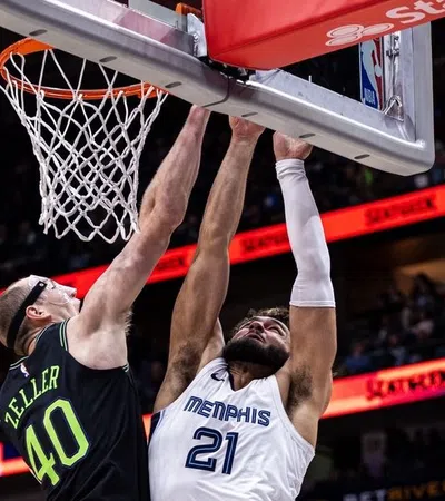 a basketball player jumping to dunk a basketball