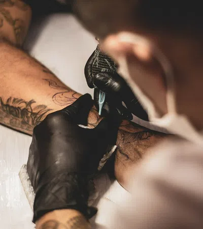 a person's hand holding a gloved hand