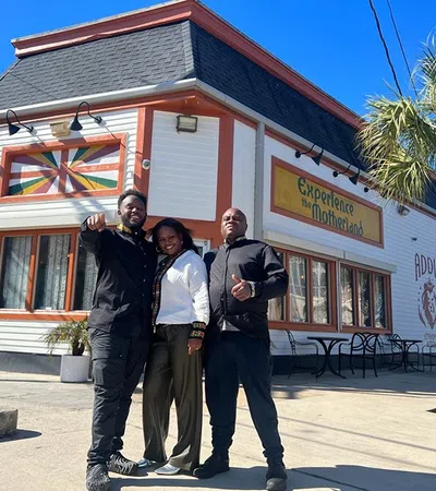 a group of people posing for a photo in front of a restaurant