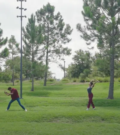 a group of people playing baseball