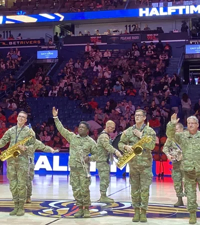 a group of men in green uniforms holding up their hands