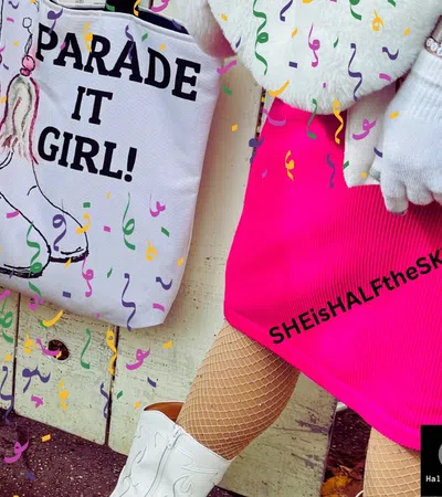 Person in bright pink skirt and white boots holding a tote bag that says 'PARADE IT GIRL!' with festive confetti around.