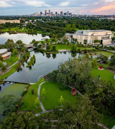 a river with a park and buildings