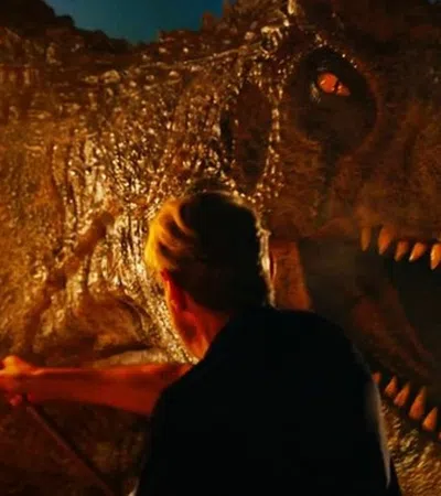 a person standing next to a dinosaur