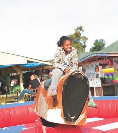 a girl sitting on a large red and black object