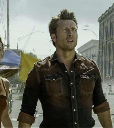 Glen Powell et al. walking on a street