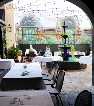 a courtyard with tables and chairs