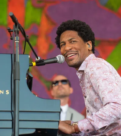 Jonathan Batiste smiling at a podium