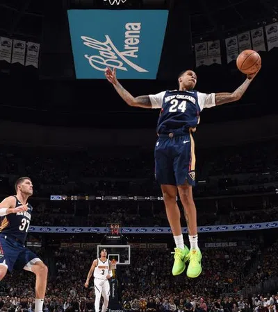 a basketball player jumping to dunk a basketball