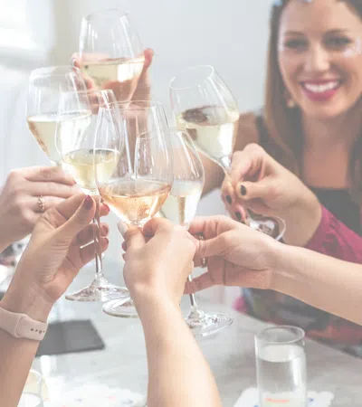 a group of people holding wine glasses