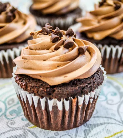 a group of cupcakes with chocolate frosting